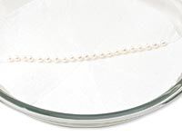 Stringed pearls in a dish